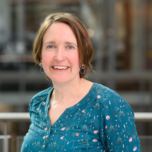 Profile picture of Portrait of academic smiling wearing colourful top