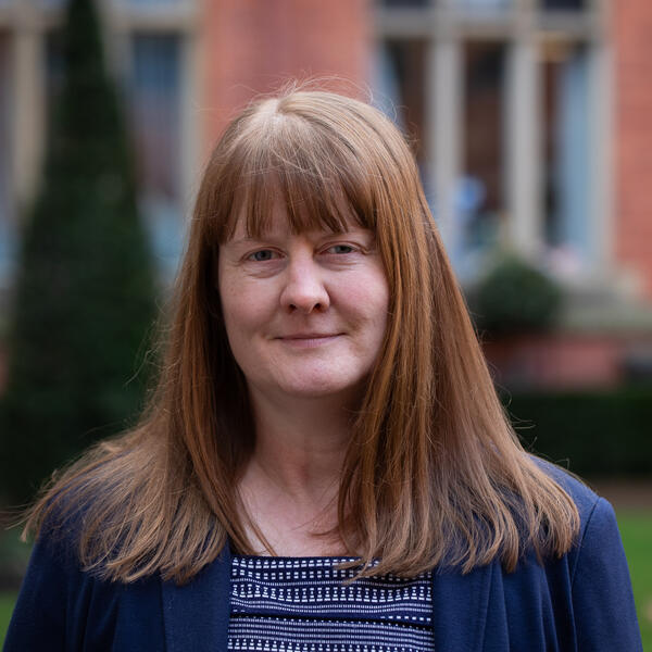 Profile picture of Portrait of a person smiling, with long straight auburn hair