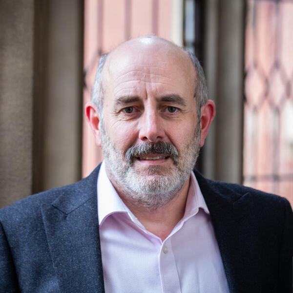Profile picture of Portrait of a person with a beard, in front of Firth Court windows