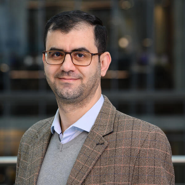 Profile picture of Researcher wearing brown blazer, glasses and smiling