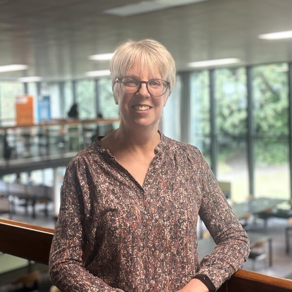 Profile picture of Helen stands on the balcony of Western Bank Library