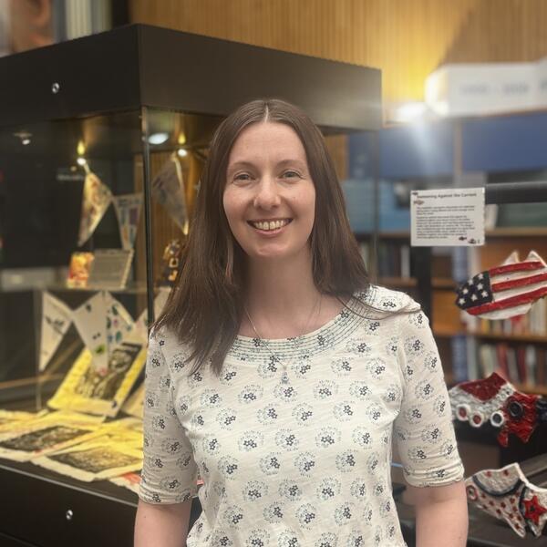 Profile picture of Anthea stands in the catalogue hall at Western Bank Library 