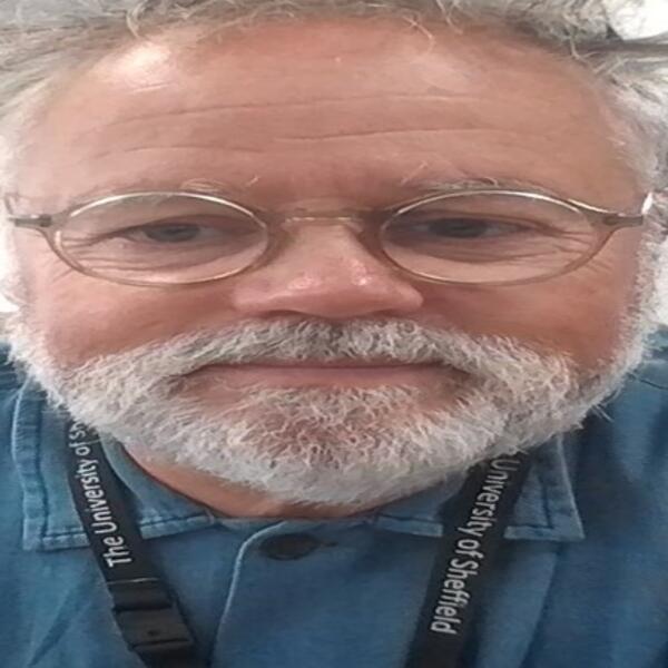 Profile picture of Michael faces the camera directly, wearing a blue shirt and glasses, with short hair and a beard.