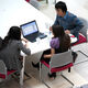 Group of Chemical and Biological Engineering postgraduates at a table with laptop