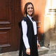 Melis in front of a grand building at the University of Oxford