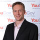 Politics graduate, Joe Twyman, pictured in front of a YouGov banner.