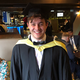 Jonathan Wright wearing graduation robes.