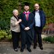 Aidan, a graduating clinical neurology student, with his parents outside a Sheffield building.