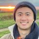 Sebastian Li looking happy in the countryside at sunset