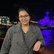 Photograph of Garima next to the River Thames in London