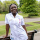 A woman in a midwifery uniform in front of Western Park