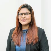 Sharmin Rahman wearing a blue top and black blazer.