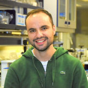 Image of Dr. Dimitar Epihov in the lab. He is wearing a green hoodie.