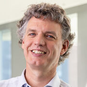 Headshot of Chris Race (white male with mid-dark hair)