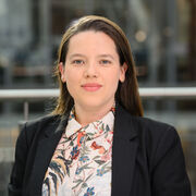 Portrait of a researcher wearing navy blazer and colourful shirt