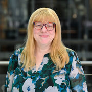 Portrait of smiling academic with colourful shirt and colourful glasses