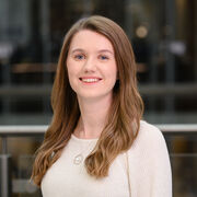 Portrait of researcher wearing white top and smiling