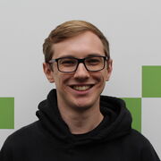 Man with blond hair and black rimmed glasses