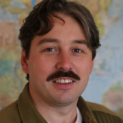 Image of Dr. Luke Dunning with a map as a background