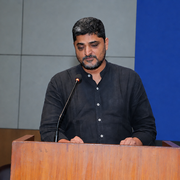 Sandeep R. Singh standing behind a podium