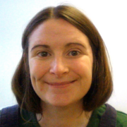 Victoria smiles directly at the camera, wearing a jumper and with chin length hair