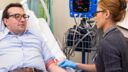 A male patient having a blood sample taken during a clinical trial
