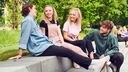 Young people sitting together in park