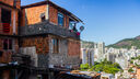 A picture of a run down house - in the background, an affluent city