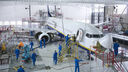 A team of engineers work to repair a plane.