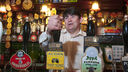 Bartender pulling pints in a pub