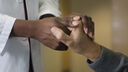 doctor holding hands with patient