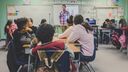 Pupils facing a teacher in the classroom