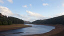 A view of a river winding through a forest in the Peak District