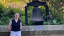 University of Sheffield student Holly Satterly stood next to the Bochum Bell in Sheffield's Peace Gardens
