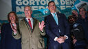 Nigel Farage and Matt Goodwin with a crowd behind them holding Reform UK placards 