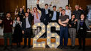 Group of students cheering on stage celebrating Emerge Awards Showcase 26