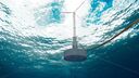 A floating wind turbine in the ocean, photographed from below