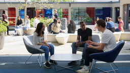Three students in front of the courtyard