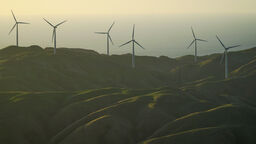 Looking down to a wind farm during a sunset in Wellington