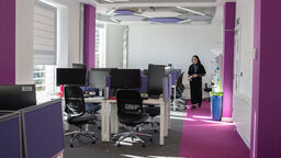  A student walking to her desk in the doctoral centre