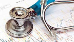 A stethoscope sitting on top of a data print out. 