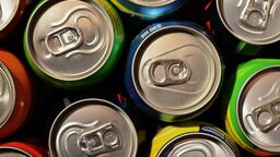 Cans of pop photographed from above. 