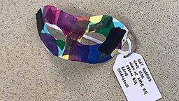 A decorated mask lists a disabled young person's dreams and ambitions.