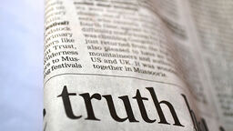 A newspaper zoomed in with the word 'truth' in large letters