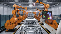 Robot arms and cars in manufacturing factory