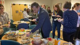 Man chooses food from buffet