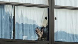 A person looking through a window