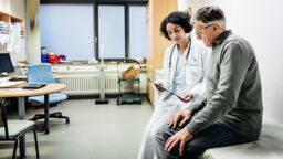 A doctor speaking to a patient