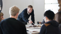People discussing a project round a table