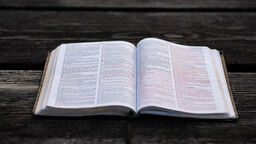 A book open on a wooden table